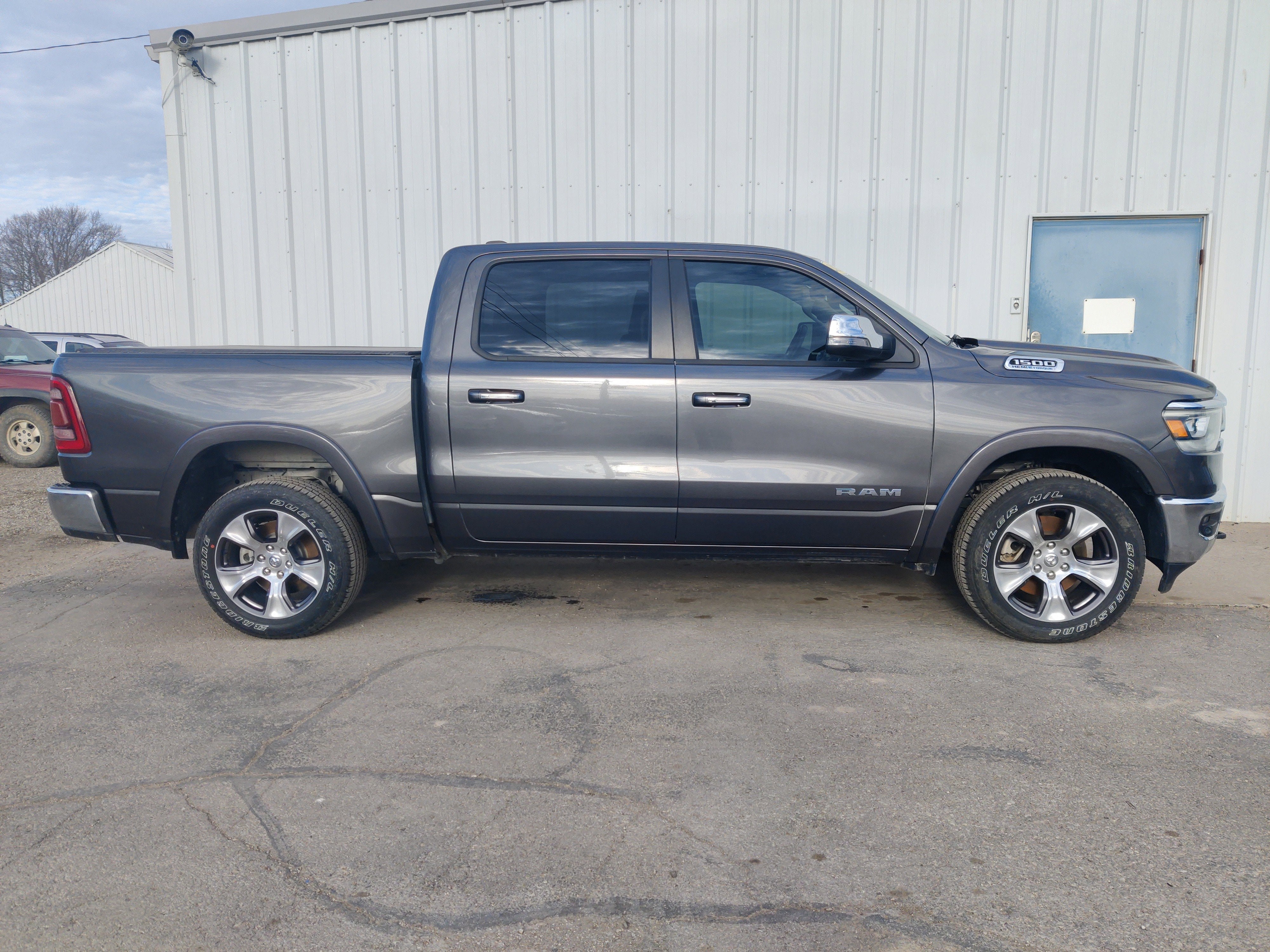 2021 RAM 1500 Laramie Crew Cab 4x4 5'7' Box in Granite Crystal Metallic Clearcoat — front three-quarter view