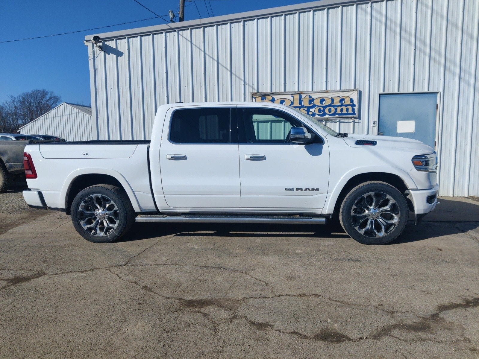 2022 RAM 1500 Limited Longhorn Crew Cab 4x4 5'7' Box in Bright White Clearcoat — front three-quarter view